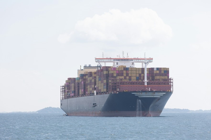 Image of a cargo ship sailing across the ocean, symbolizing how tariffs may affect contractors and their surety bonding needs.