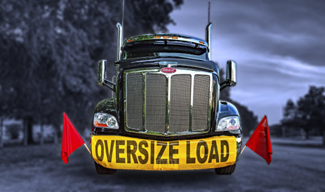 Animated image of a semi-truck with a yellow “Oversized Load” banner on the front.