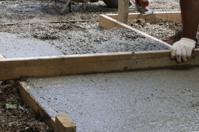 Image of poured concrete in sidewalk forms.